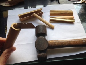 The first step in reed making is splitting cane cut to length with a stout blade and hammer to make the slips